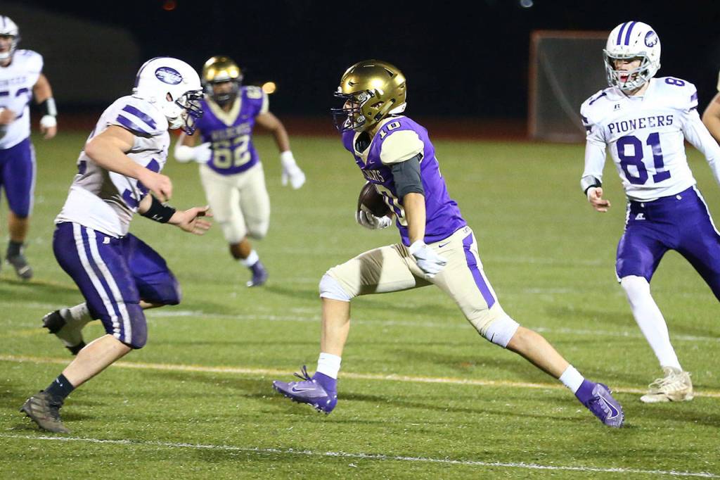 Matt Kelley tries to pick up some more yards for Oak Harbor.(Photo by John Fisken)