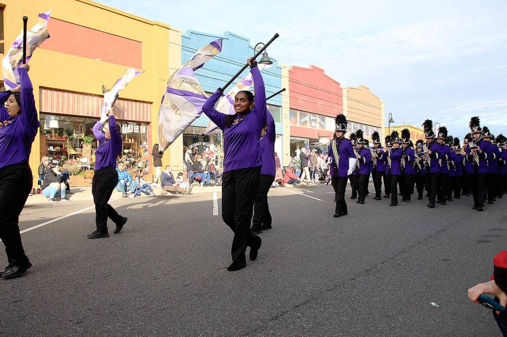 The Oak Harbor High School color guard and marching band make their way through downtown Oak Harbor Monday afternoon at the annual Veterans Day Parade.