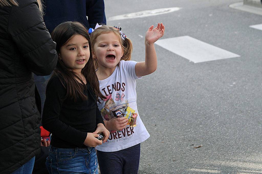 Photo by Laura Guido/Whidbey News-Times                                Piper Ponce, left, and Dylan Van Allen watch the Veterans Day Parade Monday afternoon on Pioneer Way.