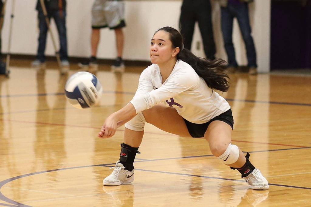 Gredina DeGuzman passes for the Wildcats.(Photo by John Fisken)