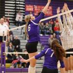 Payton Parks tips over Stanwoods block.(Photo by John Fisken)