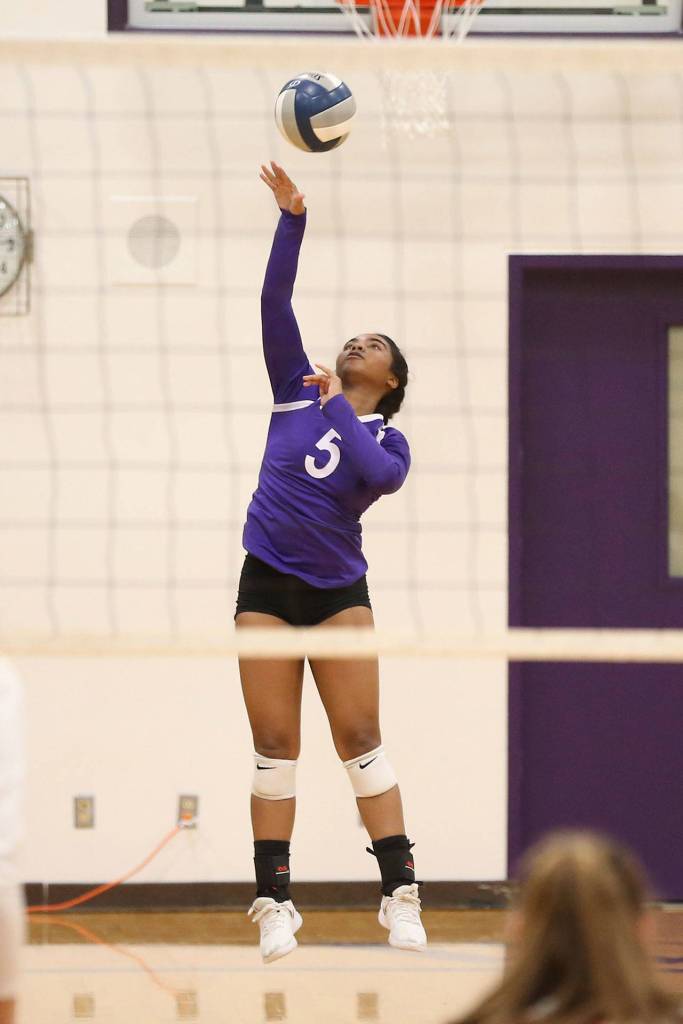 Jaslin Webster launched a serve for Oak Harbor.(Photo by John Fisken)