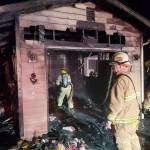 Firefighters work on a garage fire Saturday night on North Whidbey. Photo provided by North Whidbey Fire and Rescue