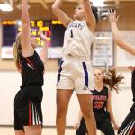 Oak Harbors Jasmine Ford shoots over Coupevilles Hannah Davidson.(Photo by John Fisken)