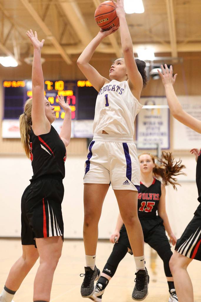 Oak Harbors Jasmine Ford shoots over Coupevilles Hannah Davidson.(Photo by John Fisken)