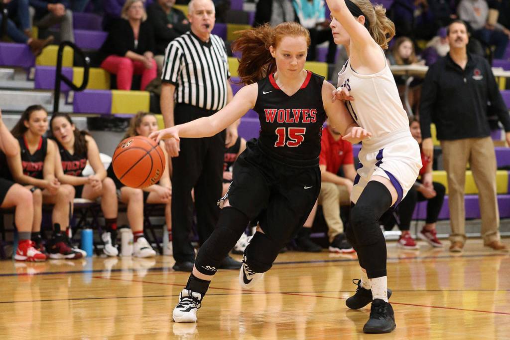 Coupevilles Maddie Georges (15) tries to dribble around the defense of Olivia Waite.(Photo by John Fisken)