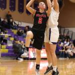 Coupevilles Scout Smith (2) powers through the defense of Jasmine Ford.(Photo by John Fisken)