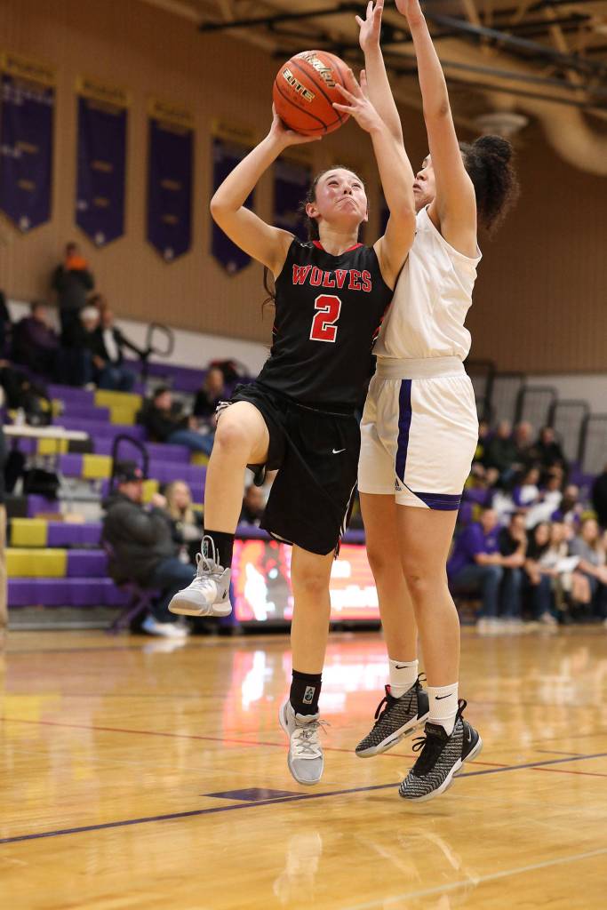 Coupevilles Scout Smith (2) powers through the defense of Jasmine Ford.(Photo by John Fisken)
