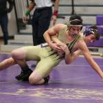 Jeremy Lujan and Miles Erikson tangle during Tuesdays purple and gold scrimmage. (Photo by John Fisken)