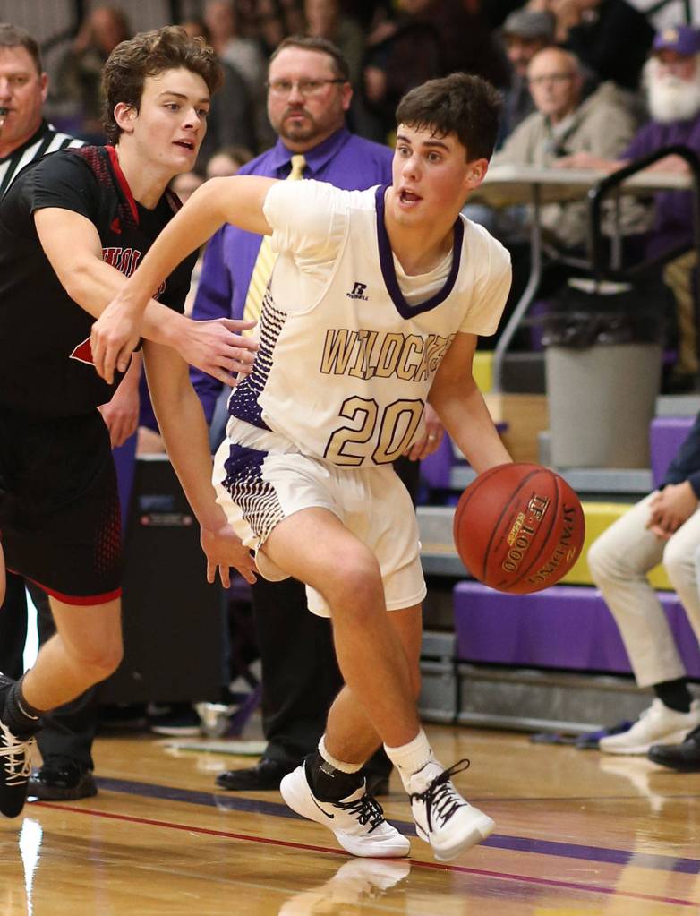 Oak Harbor Gage McLeod, right, gets by the defense of Koa Davison.(Photo by John Fisken)