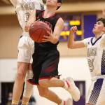Coupevilles Hawthorne Wolfe splits the defense of Will Rankin, left, and Gage McLeod, right.(Photo by John Fisken)