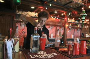 Photo by Laura Guido/Whidbey News-Times                                Captain Whidbey Inn bartender Aaron Bloom mixes a specialty cocktail as part of the Christmas pop-up Miracle. As part of the inns holiday-themed events, community members are invited to help decorate the tree in the lobby, a revival of an old tradition.