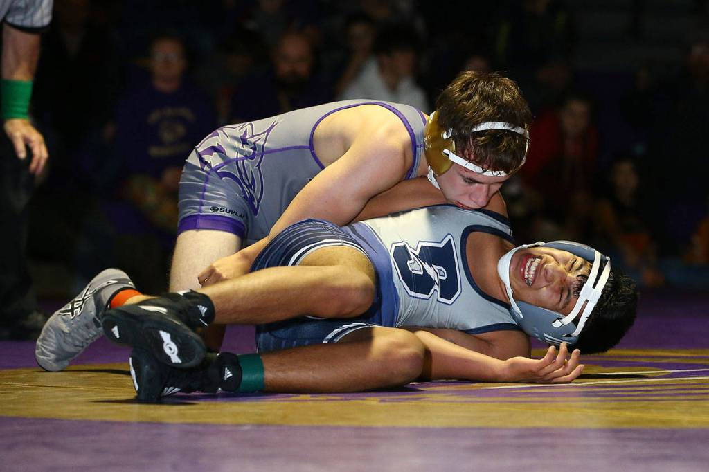 Oak Harbors Timothy Powers, top, takes control of Jose Aguilar-Lorenzo.(Photo by John Fisken)