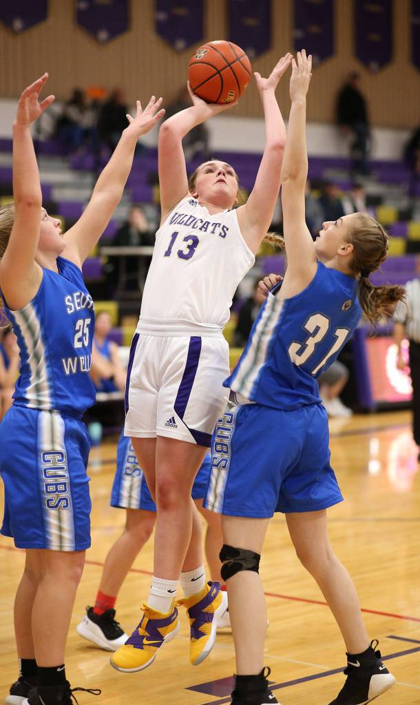 Payton Parks splits two Cub defenders for 2 points.(Photo by John Fisken)