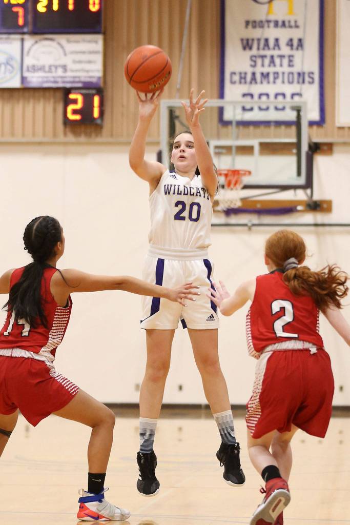 Grace Waite (20) sinks a three-pointer for Oak Harbor.(Photo by John Fisken)