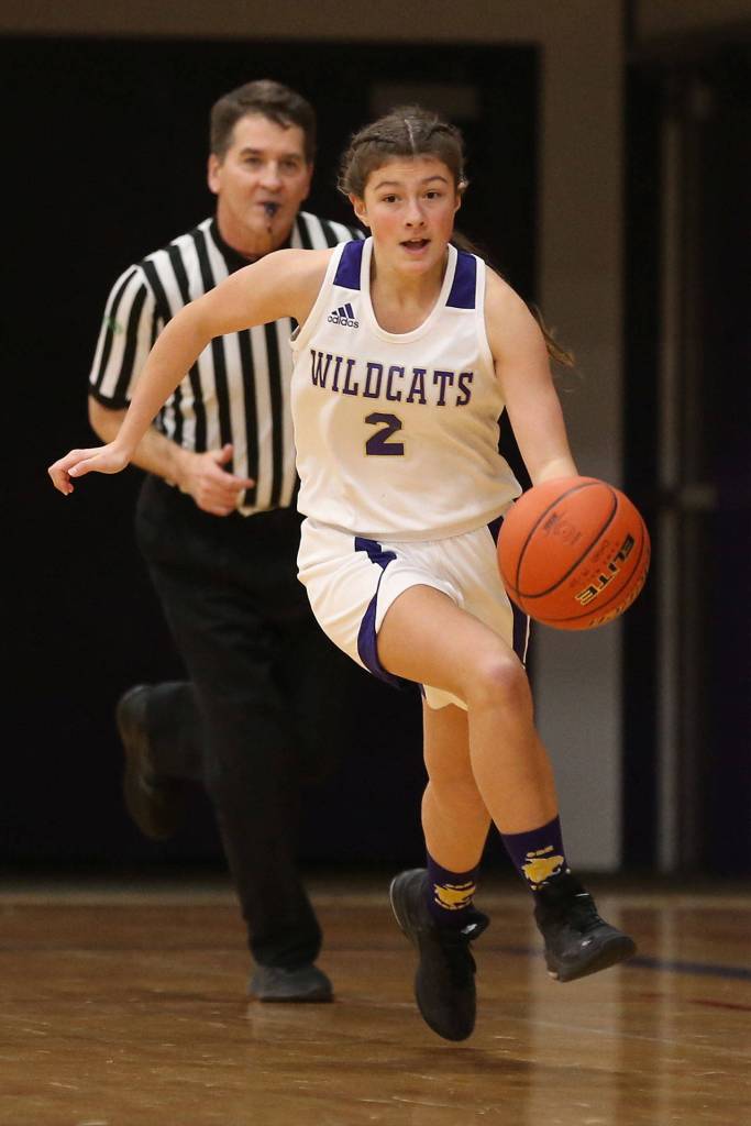 Evelyn Osburn hustles the ball up the court for the Wildcats.(Photo by John Fisken)