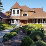 Photo provided                                Brian Kutz and his daughter Kendra, center, and wife Tuk in front of their new home, purchased while appearing on HGTVs My Lottery Dream Home.
