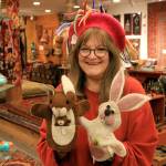 Photos by Kira Erickson /Whidbey News-Times                                Employee Deborah Eimers models a felt hat and two puppets from Music For the Eyes, a Langley store offering cultural pieces from around the world. Below, dolls of James Cagney, left and WC Fields, at Purple Moon.