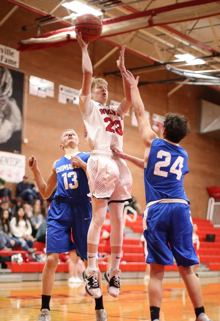 Daniel Olson splits the defense of Chimacums Cade Martin, left, and Clayton Smith.(Photo by John Fisken)