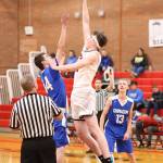 Ulrik Wells dominates the opening tip, leaping above the Cowboys Michael Bacchus.(Photo by John Fisken)