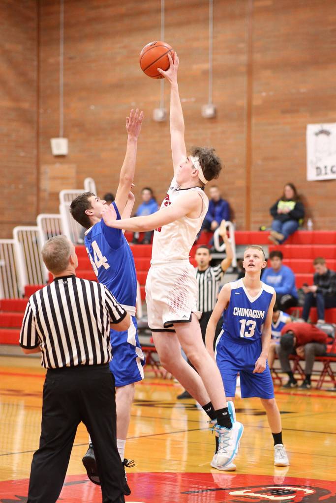 Ulrik Wells dominates the opening tip, leaping above the Cowboys Michael Bacchus.(Photo by John Fisken)