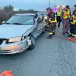 Apparatus Operator Ed Pratt, of Central Whidbey Island Fire and Rescue, uses a hydraulic rescue tool to remove a door from the heavily damaged door of a sedan on Thursday. The driver had serious injuries and was a suspect in a hit-and-run incident earlier that day. Photo provided by Central Whidbey Island Fire and Rescue