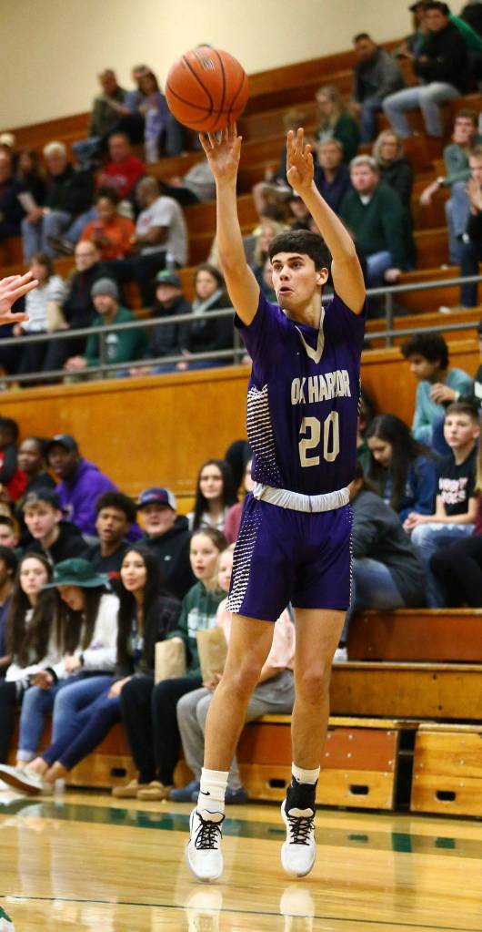 Gage McLeod launches a three-point shot for the Wildcats.(Photo by John Fisken)