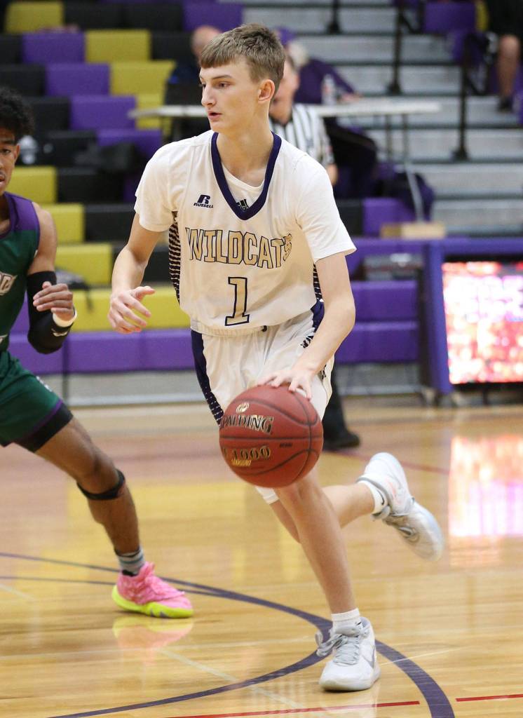 Oak Harbors Brock Boyer looks for a path to the hoop. (Photo by John Fisken)