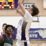 Oak Harbors Garrett Levell shoots over Edmonds-Woodways Chinedu Acholonu (0).(Photo by John Fisken)