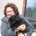 Photo by Laura Guido/Whidbey News-Times                                Island County Commissioner Janet St. Clair snuggles with her dog Bogey outside the commissioners offices in Coupeville.