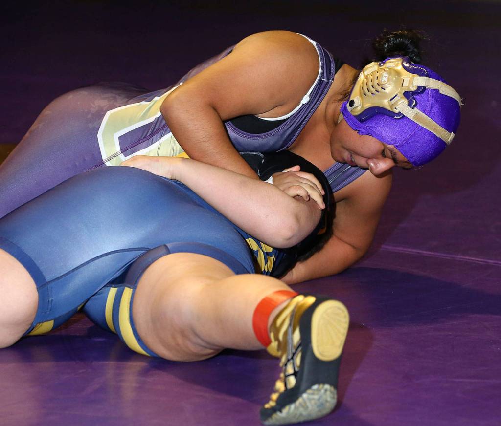 Ofelia Velasco, top, tries to pin her Burlington-Edison opponent in an exhibition match.(Photo by John Fisken)