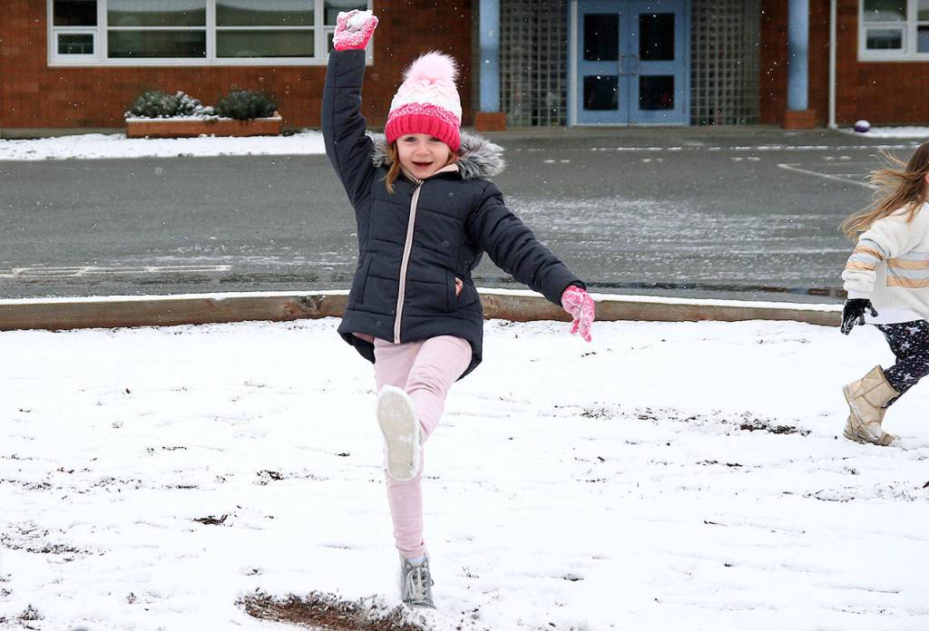 Aria Holbert hoists a snowball over her head during recess. She didnt throw it at anyone.