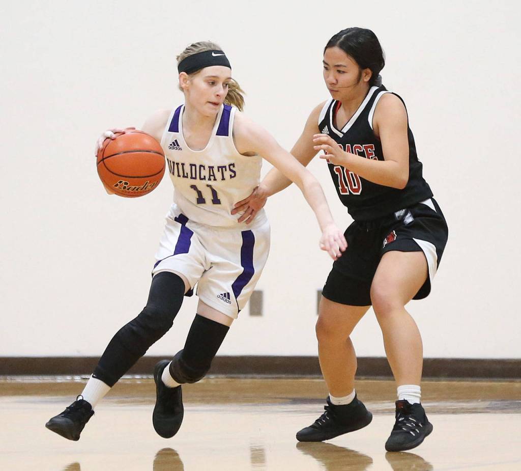 Olivia Waite (11) tries to dribble by Hawk Lindsey Ho.(Photo by John Fisken)
