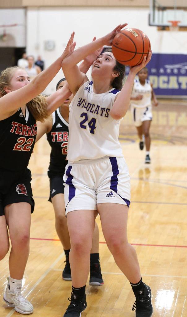 Anna Jones (24) shoots over the defense of Terraces Ainslee Beach (22). (Photo by John Fisken)