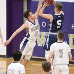 Mason Myers blocks a shot by Meadowdales Hunter Moen (5).(Photo by John Fisken)