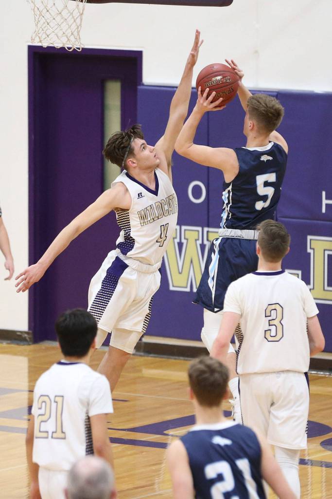 Mason Myers blocks a shot by Meadowdales Hunter Moen (5).(Photo by John Fisken)