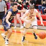 Coupevilles Mason Grove, right, beats Cedar Park Christians Jack Allen to a loose ball.(Photo by John Fisken)