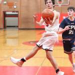 Hawthorne Wolfe uses a scoop shot to score for Coupeville.(Photo by John Fisken)