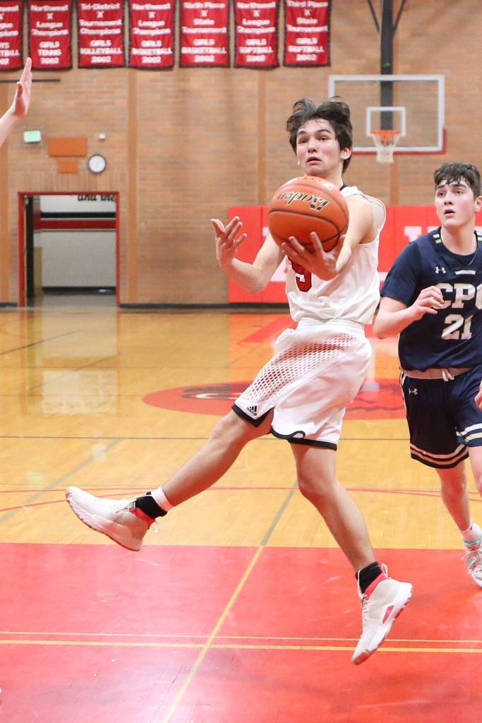 Hawthorne Wolfe uses a scoop shot to score for Coupeville.(Photo by John Fisken)