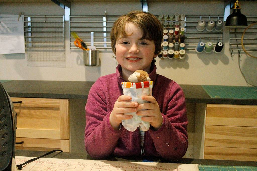 Arya Bochantin displays a finished sewn pouch, big enough to fit a sugar glider.