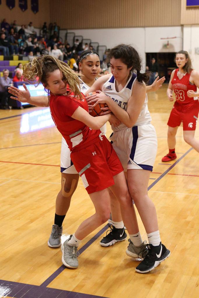 Anna Jones, right, fights for possession of the basketball.(Photo by John Fisken)