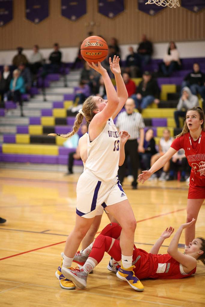 Payton Parks puts a Stanwood player down and a shot up for the Wildcats.(Photo by John Fisken)