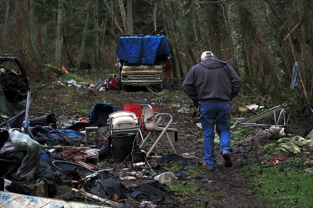 Photo by Laura Guido/Whidbey News-Times                                Dennis Phillips, of Island County Human Services, walks through a known encampment on North Whidbey during the annual Point in Time count of homeless people.