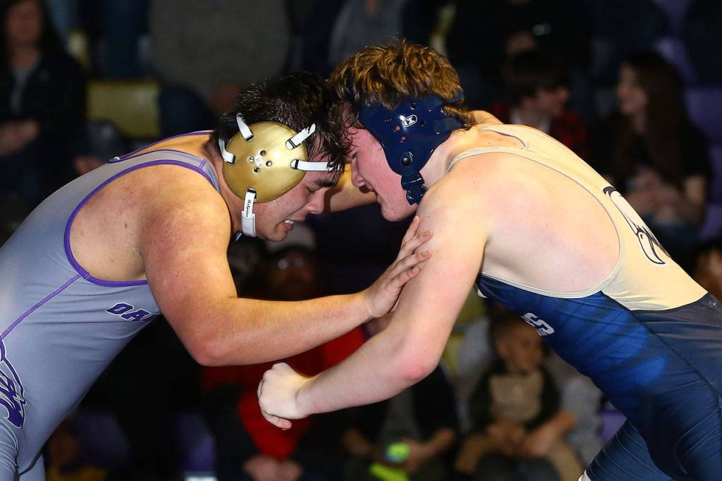Derek Jaques, left, tangles with Arlingtons Gabriel Vickers.(Photo by John Fisken)