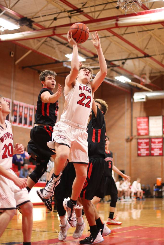 Gavin Knoblich (22) slips through the Port Townsend defense for a shot.(Photo by John Fisken)