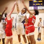 Oak Harbors Jerome Dones splits the defense of Marysville-Pilchucks TJ Severn (25) and Carson Asper (12). (Photo by John Fisken)