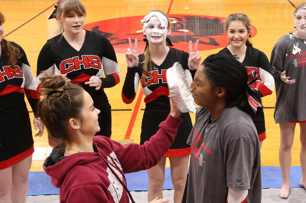 The Coupeville cheerleaders raised money for their trip to nationals by allowing themselves to be pied in the face. Here, JaTarya Hoskins, right, gets hit by Maya Toomey-Stout. (Photo by John Fisken)
