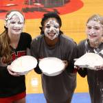 The top earners from the Coupeville cheer squad for the pie-in-the-face fundraiser were Emily Fielder, left, JaTarya Hoskins and Mica Shipley.(Photo by John Fisken)