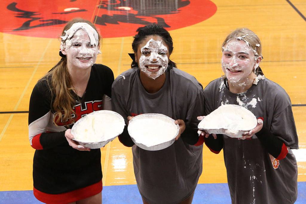 The top earners from the Coupeville cheer squad for the pie-in-the-face fundraiser were Emily Fielder, left, JaTarya Hoskins and Mica Shipley.(Photo by John Fisken)