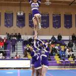 Photo by John Fisken                                Oak Harbors Alyssa Carlon, flyer; Jada Jones, left; Krystal Wyum, right; and Audrey Moyes perform at last Fridays basketball game.